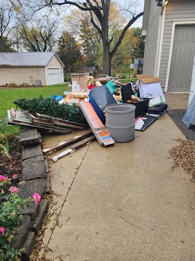 Dumpster being loaded with debris for Estate Cleanout Dumpster Rental in Republic